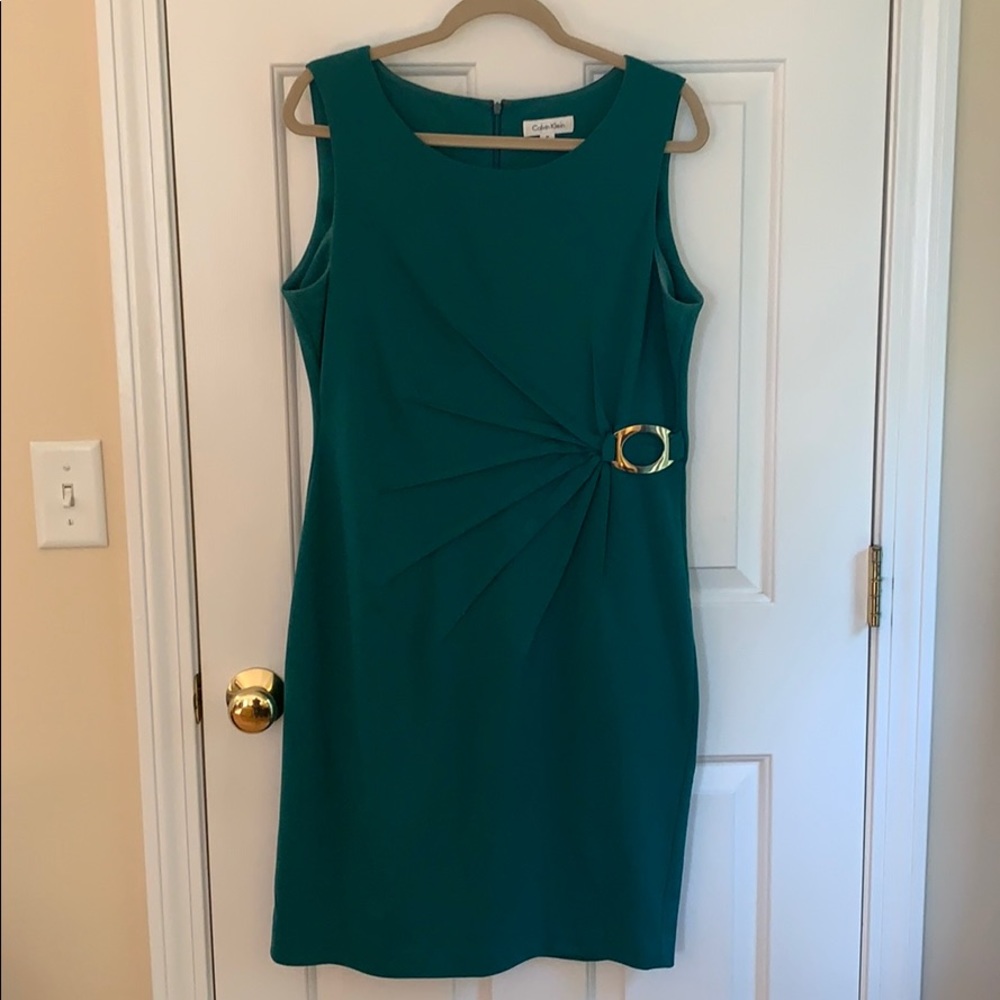 Green dress with gold ring accent